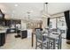 Open-concept dining area adjacent to a modern kitchen, featuring sliding glass doors to the backyard at 21834 Southern Charm Dr, Land O Lakes, FL 34637