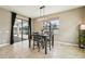 Dining room featuring modern lighting, neutral paint, and view of screened patio and pool at 21834 Southern Charm Dr, Land O Lakes, FL 34637