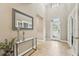 Bright foyer features high ceilings, tiled floors, entry door with sidelights, and console table at 21834 Southern Charm Dr, Land O Lakes, FL 34637
