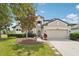 Charming two-story home featuring manicured landscaping and a spacious two-car garage at 21834 Southern Charm Dr, Land O Lakes, FL 34637