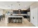 Well-lit kitchen featuring a large island, modern appliances, dark cabinetry, and tile flooring at 21834 Southern Charm Dr, Land O Lakes, FL 34637