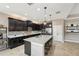 Spacious kitchen featuring a large island, stainless steel appliances, and dark wood cabinetry at 21834 Southern Charm Dr, Land O Lakes, FL 34637