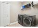 Convenient laundry area equipped with a washer, dryer, and practical storage solutions at 21834 Southern Charm Dr, Land O Lakes, FL 34637