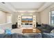Elegant living room with custom built-ins, a large TV, comfortable seating, and great natural light at 21834 Southern Charm Dr, Land O Lakes, FL 34637