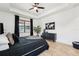 The main bedroom boasts tile floors, a dark color palette, and natural light at 21834 Southern Charm Dr, Land O Lakes, FL 34637