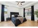 The main bedroom offers a tray ceiling, fan, and windows overlooking the backyard at 21834 Southern Charm Dr, Land O Lakes, FL 34637