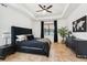 The main bedroom features a tray ceiling, fan, tile floors, and outdoor views at 21834 Southern Charm Dr, Land O Lakes, FL 34637