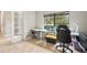 A bright home office with a large window, a comfortable chair, and a desk with sewing machine at 21834 Southern Charm Dr, Land O Lakes, FL 34637