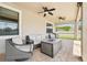Covered patio with outdoor furniture, ceiling fans, and a view of the backyard and landscaping at 21834 Southern Charm Dr, Land O Lakes, FL 34637