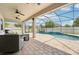 The screened-in lanai boasts a luxurious pool, seamlessly merging indoor and outdoor living at 21834 Southern Charm Dr, Land O Lakes, FL 34637