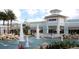 A beautiful outdoor shopping center with a water feature and various stores, including Polo Ralph Lauren at 21834 Southern Charm Dr, Land O Lakes, FL 34637