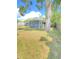 Spacious fenced yard, showcasing shade trees and a well-maintained lawn providing a private setting at 2400 13Th S Ave, St Petersburg, FL 33712
