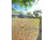 Expansive fenced backyard space with mature trees and a well-maintained lawn offering privacy at 2400 13Th S Ave, St Petersburg, FL 33712