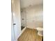 Updated bathroom featuring a tiled shower and modern fixtures and hardwood flooring at 2400 13Th S Ave, St Petersburg, FL 33712