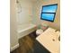 Bright bathroom with a bathtub, vanity, and window for natural light at 2400 13Th S Ave, St Petersburg, FL 33712