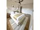 Bright bedroom featuring a ceiling fan, warm hardwood floors, and ensuite closet at 2400 13Th S Ave, St Petersburg, FL 33712
