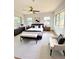 Bright and airy bedroom boasting a ceiling fan, large windows, and stylish decor at 2400 13Th S Ave, St Petersburg, FL 33712