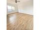 A bright bedroom with a ceiling fan and large window with hardwood flooring at 2400 13Th S Ave, St Petersburg, FL 33712