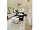 Charming bedroom with ceiling fan, large windows providing natural light, and an ottoman at 2400 13Th S Ave, St Petersburg, FL 33712