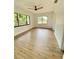 Bright bedroom with laminate flooring, multiple windows providing ample natural light, and neutral paint at 2400 13Th S Ave, St Petersburg, FL 33712