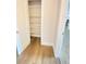 Walk in closet featuring built in shelving with hardwood flooring at 2400 13Th S Ave, St Petersburg, FL 33712