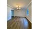 Elegant dining room with wood flooring, chandelier, crown molding, and large window at 2400 13Th S Ave, St Petersburg, FL 33712