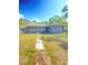 Charming single story home with a walkway and lush trees, showing off its inviting exterior at 2400 13Th S Ave, St Petersburg, FL 33712