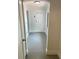 Clean hallway with neutral walls and gray floors leads to a bright white door at 2400 13Th S Ave, St Petersburg, FL 33712