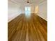 Spacious living room with laminate flooring, crown molding, and abundant natural light at 2400 13Th S Ave, St Petersburg, FL 33712
