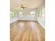 Bright living room with neutral paint, ceiling fan, wood floors and plenty of natural light at 2400 13Th S Ave, St Petersburg, FL 33712
