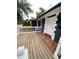 View of the wooden front porch, white railings, and brick walkway, leading to the front door of the home at 2400 13Th S Ave, St Petersburg, FL 33712