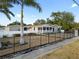 Charming home with a fenced yard, featuring a screened porch, and enhanced by mature trees and landscaping at 2715 9Th N Ave, St Petersburg, FL 33713