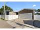 Exterior shot of a two-car garage with a white garage door, light brown siding, and a concrete driveway at 2715 9Th N Ave, St Petersburg, FL 33713