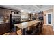 Spacious kitchen with dark wood cabinets, stainless steel appliances, and a large island with seating at 2715 9Th N Ave, St Petersburg, FL 33713