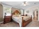 Comfortable main bedroom with a large carved wood bed, ceiling fan, and natural light from windows at 2715 9Th N Ave, St Petersburg, FL 33713