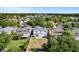 Aerial view of home showcasing the neighborhood and surrounding trees at 27330 Coral Springs Dr, Wesley Chapel, FL 33544