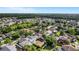 A neighborhood of single-Gathering homes surrounded by a green canopy of trees at 27330 Coral Springs Dr, Wesley Chapel, FL 33544
