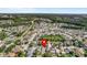 Sprawling aerial view of a vibrant residential community surrounded by lush greenery and blue skies at 27330 Coral Springs Dr, Wesley Chapel, FL 33544