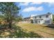 Expansive fenced backyard with lush lawn and mature trees, offering privacy at 27330 Coral Springs Dr, Wesley Chapel, FL 33544