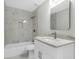Bright bathroom features a marble tiled shower-tub, modern vanity, and sleek fixtures at 27330 Coral Springs Dr, Wesley Chapel, FL 33544