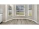 Bright breakfast nook with gray wood-style flooring and a bay window at 27330 Coral Springs Dr, Wesley Chapel, FL 33544