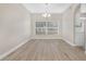 Dining room featuring modern chandelier, luxury vinyl flooring, and natural light at 27330 Coral Springs Dr, Wesley Chapel, FL 33544