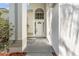 Inviting front entrance with white door, sidelights, and decorative arch window for natural light at 27330 Coral Springs Dr, Wesley Chapel, FL 33544