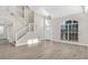 Bright, airy living room with vaulted ceiling, large windows, and open staircase at 27330 Coral Springs Dr, Wesley Chapel, FL 33544