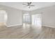 Open-concept living room featuring hardwood floors and arched doorways at 27330 Coral Springs Dr, Wesley Chapel, FL 33544