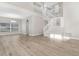 Bright, airy living room with luxury vinyl flooring, stairs to the second floor, and neutral paint at 27330 Coral Springs Dr, Wesley Chapel, FL 33544