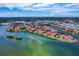 Aerial view of the community with waterfront access, lush landscaping and stunning architecture at 2755 Via Capri # 1223, Clearwater, FL 33764