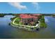 Stunning aerial view of waterfront condos with red tile roofs and lush landscaping in a beautiful community at 2755 Via Capri # 1223, Clearwater, FL 33764