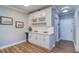 Charming bar area features custom white cabinetry, wine rack, and beverage cooler, perfect for entertaining at 2755 Via Capri # 1223, Clearwater, FL 33764