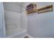 Clean bathroom featuring a shower with white tile and modern towel storage at 2755 Via Capri # 1223, Clearwater, FL 33764